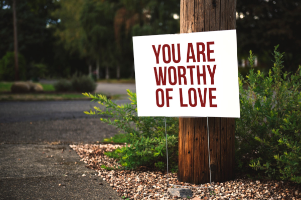 Sign reading "You deserve to be loved"