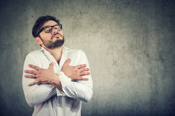 Man embracing himself in deep love