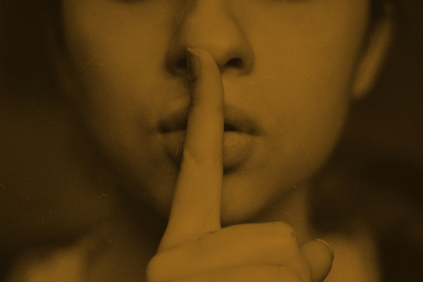 Woman with finger to lips