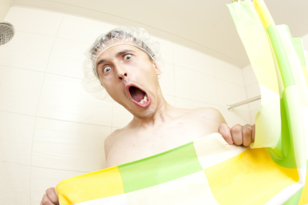 Adult man in bathroom screaming